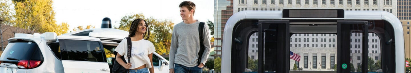 Two people standing next to an autonomous vehicle