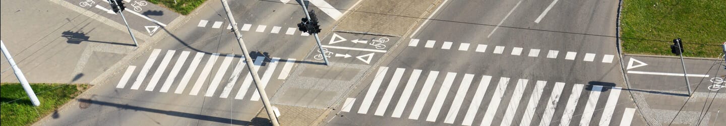 Aerial view of street intersection with lights, crosswalks and bike paths